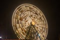 Ferris wheel in motion at the amusement park, night illumination. Long exposure Royalty Free Stock Photo