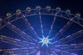 Ferris wheel at night with a motion blur and lens flares at the christmas market Royalty Free Stock Photo