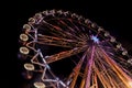 Ferris wheel at night with a motion blur and lens flares Royalty Free Stock Photo