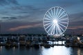 Ferris wheel at night, reflection in the water Royalty Free Stock Photo