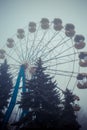 Ferris wheel in an old abandoned park in the autumn in thick fog Royalty Free Stock Photo