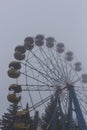 Ferris wheel in an old abandoned park in the autumn in thick fog Royalty Free Stock Photo