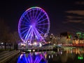The ferris wheel of the old port of Montreal with the colors of the rainbow concerning the covid-19