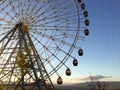 Ferris wheel over a blue sky