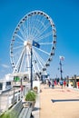 Ferris wheel and pier on the Potomac River in National Harbor, Maryland. A place for walks and recreation for citizens