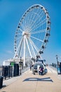 Ferris wheel and pier on the Potomac River in National Harbor, Maryland. A place for walks and recreation for citizens