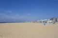 Ferris wheel and the Pier at Scheveningen beach in autumn, Den Hague, the Netherlands, with empty beach chairs Royalty Free Stock Photo