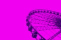 Ferris wheel on the purple background duotone image