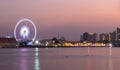 Ferris wheel river side at twilight time on Bangkok cityscape