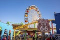 Ferris wheel and roller coaster seen through Route 66 road sign at Pacific park