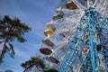 ferris wheel is rounding over the blue clear sky