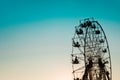 ferris wheel silhouette against clear blue orange sky Royalty Free Stock Photo
