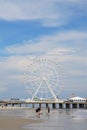 The Ferris Wheel at Steel Pier and family playing on beach