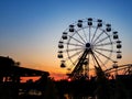 Ferris wheel in sunset. Big wheel with cabins