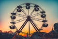 Ferris wheel at sunset - popular park attraction Royalty Free Stock Photo