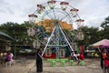 Ferris wheel toy at outdoor for thai family people and children kid select playing amusement carnival park in street market bazaar