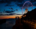 Ferris wheel on the water at sunset Royalty Free Stock Photo