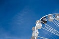 Ferris wheel with white cabins and one black one