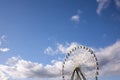 Ferris wheel with white cabins and two black