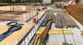 Bundles of steel rebar rods and grids into reinforced cement concrete at a building site