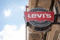 Levi`s logo sign at storefront and blue sky