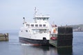 Ferry arrival at dock port lowering gate ramp at ocean sea terminal