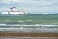 ferry arriving in the port of Calais with the English cliffs on the horizon