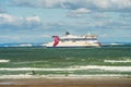 ferry arriving in the port of Calais with the English cliffs on the horizon