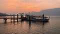 Ferry Boat arriving in the Harbor of Luino on the lake Maggiore at Sunset.