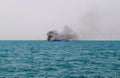 Ferry boat of Bay of Bengal smoke coming from its chimney. Black exhaust fumes coming from the chimney of a moored tanker.