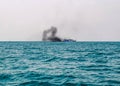 Ferry boat of Bay of Bengal smoke coming from its chimney. Black exhaust fumes coming from the chimney of a moored tanker.