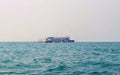 Ferry boat of Bay of Bengal smoke coming from its chimney. Black exhaust fumes coming from the chimney of a moored tanker.