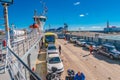 Ferry boat is loaded with cargo cars and tourist buses to cross Strait of Magellan at Punta Delgada into Tierra del Fuego island,