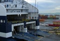 Ferry boat loading or unloading in seaport. Large ferryboat docked in sea harbor, big ship at port pier Royalty Free Stock Photo