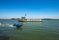 Ferry Boat in motion in the Venice Lagoon in front of Torcello and Burano Island