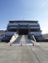 Ferry Boat Ship with open Ramp and empty Car Deck ready to board cars and passengers. Car dock ramp of a ferry docked at dock Royalty Free Stock Photo