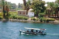 Ferry boat and village at Nile river in Egypt