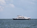 Ferry boat Zuiderzee sailing on lake IJsselmeer and wind generators of windfarm, Netherlands Royalty Free Stock Photo