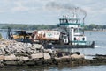 Ferry carrying a garbage truck, near dock