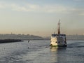 A ferry carrying passengers in istanbul at sunset