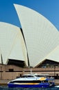 A ferry cruises past the Sydney Opera House Royalty Free Stock Photo