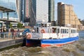 A ferry docks at the Canary Wharf ferry terminal on the river Thames in London