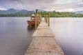 Ferry at Jetty on Glass-like lake Derwentwater in Keswick in England. Royalty Free Stock Photo