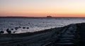 A ferry on the horizon at sunset. Royalty Free Stock Photo