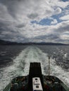 Ferry leaving a trail as it passes through the sea water, Skye island, Scotland Royalty Free Stock Photo