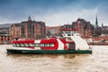 Ferry navigating on the Elbe river in a cold cloudy winter day Royalty Free Stock Photo