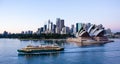 Ferry passes in front of Sydney Opera House with the city in the background Royalty Free Stock Photo