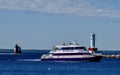 A Ferry Passes Between Round Island Lighthouse