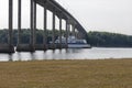Ferry Passing Underneath a Bridge Royalty Free Stock Photo