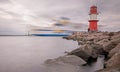 Ferry ship is passing the light beacon at the port Rostock-WarnemÃÂ¼nde